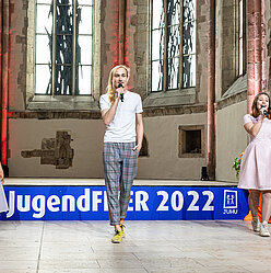 eine Gruppe von Menschen, die auf einer Bühne stehen